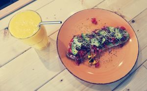 Avocado on toast and orange, mango, lime juice  at Natural Nada mas Green Bar in Lanzarote