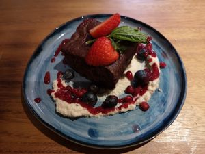 Chocolate brownie with cashew cheese and raspberry coolie at Indigo Greens - Duke St Market in Liverpool