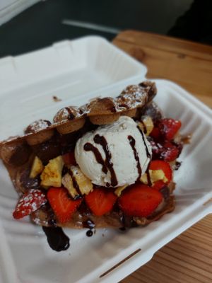 vegan waffle with: vegan ice cream, strawberries, vegan honeycomb, vegan chocolate spread and vegan chocolate sauce at Kawaffle in Plymouth