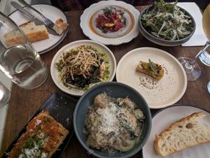 L to R: Focaccia, burnt eggplant dip, salad, charred brassicas, parsnip rosti, garlic bread, mushroom gnocchi, focaccia at Ballard's in Thornbury