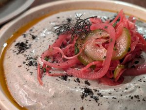 Burnt Eggplant dip with smoked tomato oil, featuring pickled vegetables and dill as garnish at Ballard's in Thornbury