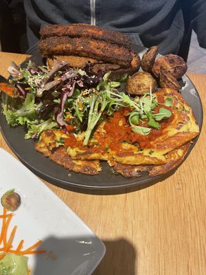 Irene’s Big Breakfast. Chick pea omelette with ranchero sauce, tempeh bacon, salad, sliced potates, and two pieces of buttered sourdough bread / Le Grand Petit déjeuner  at Hello 123 in Montreal