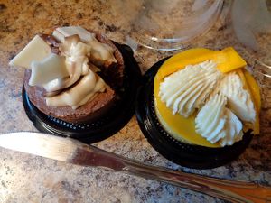 Vegan cheesecakes from VegFest: chocolate and mango yuzu. Took a small slice from each. Heavenly!!! at Foodhisattva in Cleveland Heights