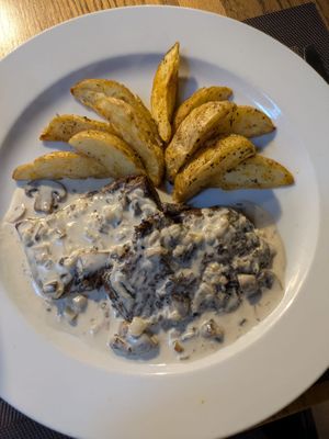 Steak with mushroom sauce and wedges at Vegan In Our House in Cairo
