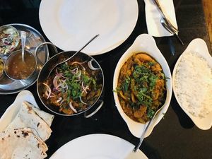 Vegan dishes with rice, bread and dips at Maharaja Indian Cuisine in Chipping Campden