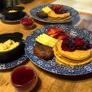 Vegan breakfast! Chickpea pancakes with fruit sauce, breakfast patty, cheezy grits, and juice shot of the day (beet, celery, apple, orange, ginger) at Old Caledonian Bed & Breakfast in Caledonia