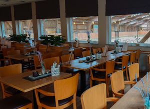 Part of the restaurant, with direct view of the riding hall.  at Hotte Hü in Dusseldorf