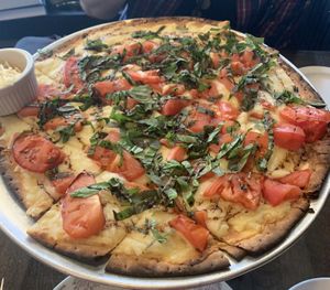 Caprese Pizza with vegan cheese  at L.May Eatery in Dubuque