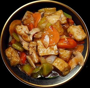 Crispy tofu cubes enveloped in a perfectly balanced sweet and tangy sauce, accented by colorful vegetables for an unforgettable flavor contrast. at Noodle House in Istanbul