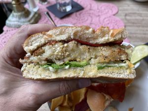 Breaded aubergine burger with vegan bacon, baby gem lettuce, and a vegan basil mayonnaise served with chips and a side of cucumber pickle.  at The Butterfly and the Pig - City Centre in Glasgow