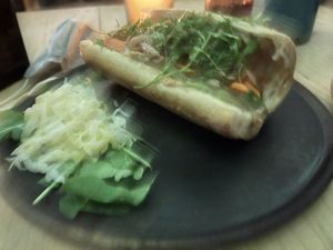 Bahn mi (I didn’t focus camera. Sorry).  The site is kohl slaw or fermented cabbage.. not cheese.  When I asked what could be made vegan, the waiter told me this. 100 pesos. at Boulenc in Oaxaca