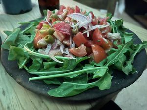 I really liked this salad a lot. Arugula , tomatoes, onion, olives.  This is the cheaper of two salads and has nothing nonvegan by default. 100 pesos  at Boulenc in Oaxaca