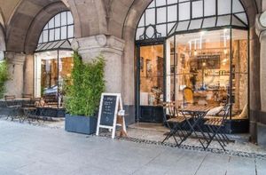 Outdoor seating under arcades and vintage furnitures inside at Fox in Metz