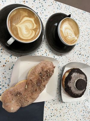 Maple and pecan twist and Oreo donut with oat flat whites  at WHO CULT in Bridgend