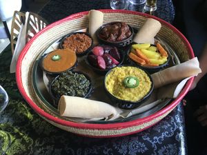 Veggie platter with rolls of injera bread at Zaion Horn of Afrika in Umea