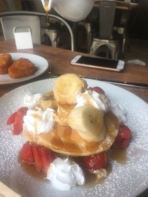 Vegan strawberry and banana pancakes with maple syrup at Stag Coffee in Canterbury