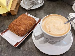 Cappuccino with almond-rice milk and a choco croissant at Senso Unico in Olbia