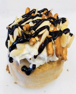 Almond Frosting, Sliced Almonds, Pretzels, and Chocolate Sauce at Cinnaholic in Concord
