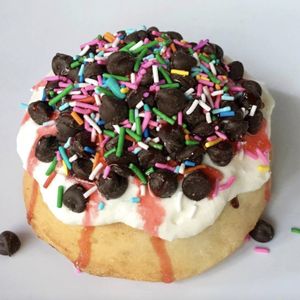 Vanilla Frosting with Chocolate Chips, Strawberry Drizzle & Rainbow Sprinkles at Cinnaholic in Concord