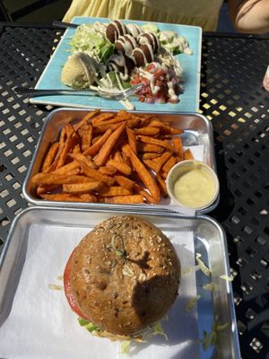 Lentil/ mushroom burger, sweet potato fries and falafel over greens and brown rice with hummus , avocados and pick and tahini   at Turf Surf & Earth in Somerville