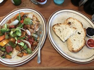 Yummy breakfast!! Sautéed veggies and potatoes with homemade fire roasted salsa on top and a side of homemade sourdough bread and jam.  at The Sunset Cafe in Cle Elum