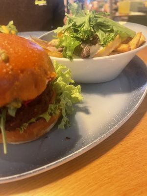 Vegan umami patty with hummus & pesto sided with loaded fries with avocado and vegan mayo  at Hans im Glück  in Bremen