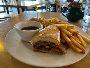 Seitan philly cheese steak with side dipping sauce and fries. at Tasty Harmony in Fort Collins
