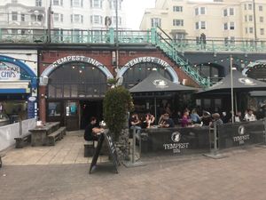 Main building and part of outdoor seating.  Located just below Kings Rd by the sea, near the intersection with West St. at Tempest Inn in Brighton