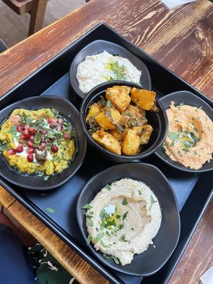 Veggie mezze - usually comes with dolmades, but we got an extra dip instead. Spiced potatoes in the middle   at Damascena Coffee House - Temple Row in Birmingham