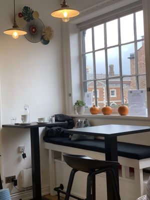 There are four tables in the café.  at Vegan Deva in Chester