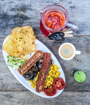 Big brekkie full English breakfast with Beyond Sausage and tofu scramble, as well as coffee, wheatgrass, and fresh vegetable juice at Vegan Junkie in Phuket
