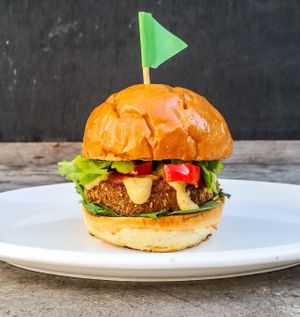 Cauliflower power burger! Homemade cauliflower, mushroom and chickpea herby patty, with homemade cashew cheese, homemade ketchup, grilled veggies, spinach and Coriander.  at Vegan Junkie in Phuket