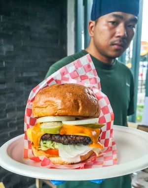 Beyond Beef burger with homemade vegan house sauce, vegan cheese, bun toasted in homemade vegan butter. Home-pickled dill pickles!  at Vegan Junkie in Phuket