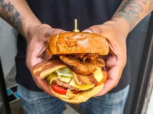 The wake n Bakon burger! With homemade smoky maple bbq sauce, vegan bacon, vegan cheese, vegan meat and homemade onion rings.  at Vegan Junkie in Phuket