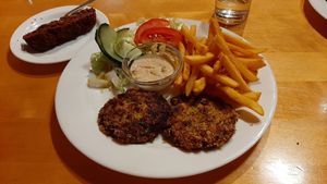 Bean patties with fries and tahini dip. Banana cake on the background. at Mäeküla Kõrts in Paide