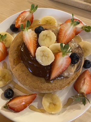 American pancakes with chocolate sauce, peanut butter banana and strawberry at Mukka Coffee in Mallorca
