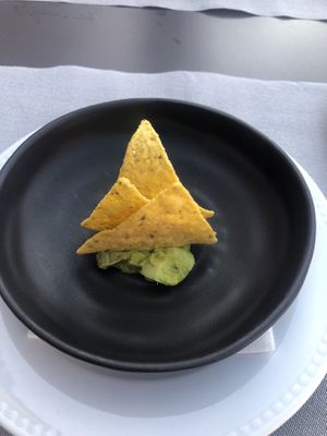 A little snack, chips and guacamole. Really good, wish there was more  at Incomum in Sintra