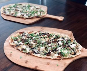 Disco Volante!
A house-made four cheese and fig flatbread with gorgonzola, goat cheese, romano, and gruyere.  Garnished with a drizzle of balsamic reduction, truffle oil, honey and at Delicious Raw Kitchen and Juice Bar in Miami Beach