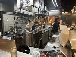 Boss man recording a couple tourists  at Menbaka Fire Ramen めん馬鹿 in Kyoto