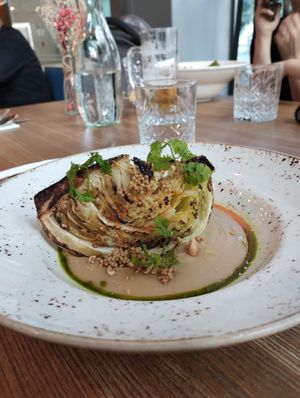 Baked cabbage in white bean puree with mustard seeds and nuts. Divine combination of flavours  at Spojka Karlin in Prague