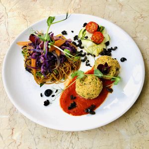 Rice noodles, purple cabbage, roasted carrot, soy sauce; grain balls, mushrooms, cider vinegar, coriander, baked pepper puree; courgettes bled, cherry tomatoes; dehydrated olives at rePlaneta in Lisbon