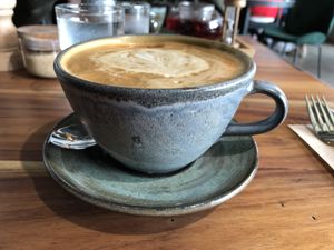 Latte in mug at Good Food Emporium Cafe - Illume in Narre Warren