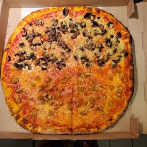 Violife cheese. Half mushrooms and pineapple and half chicken. at Pizza Gusta in Bronx