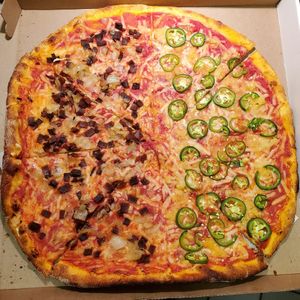 Follow Your Heart cheese. Half bacon and onions and half jalapeño and pineapple. at Pizza Gusta in Bronx