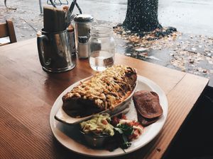 Vegan breakfast burrito baked with gauc and a side of veggie bacon at The Burrow in Vancouver