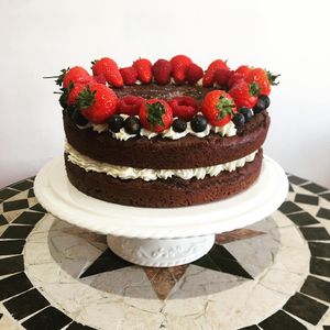 Moist and rich chocolate cake with fresh fruit  at KUB in Teignmouth