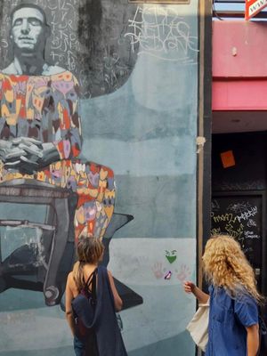 admiring and reading amazing collages ideas and phrases on Palermo walls at Florentine Vegan Experiences in Buenos Aires