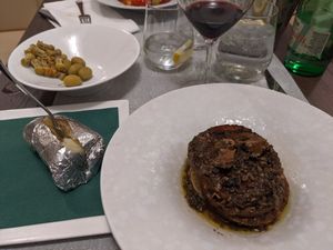 Truffle seitan mignon, a jacket potato, and local wine and olives at Dalmatino in Hvar