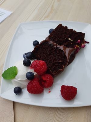 chocolate and orange vegan sponge with chocolate topping. deliciously fluffy, soft and moist with vegan creme fraiche and fresh fruit. at Nourish in Letchworth