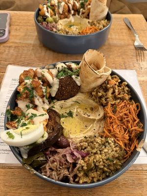 Chef’s plate with cauliflower shawarma plate in the backgroundd  at Pois Chiche in Brussels